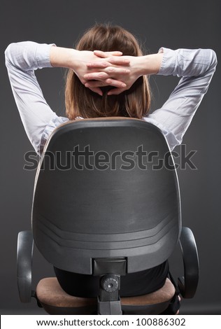 Beautiful business woman sitting in chair back