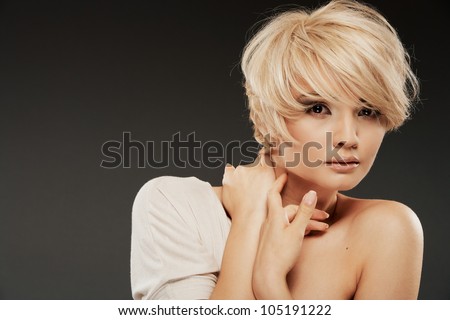 Close up young woman portrait.  Beauty studio shoot. Healthy clean skin and perfect makeup on beautiful face of white model with short blonde hair.