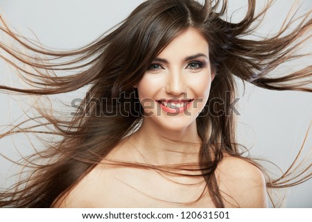Woman face with hair motion on white background isolated close up portrait. Female model with long hair.