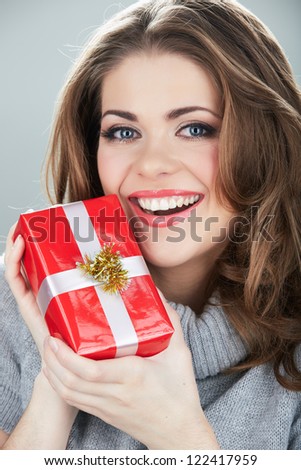 Gift box woman hold against gray background. Close up Isolated portrait of young smiling model.