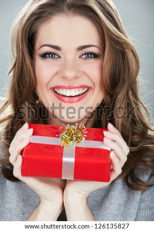 Gift box woman hold against gray background. Close up Isolated portrait of young smiling model.