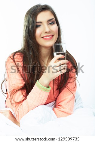 Woman bed portrait. Female model lying in bed. Woman drink water seating in bed . White background isolated .