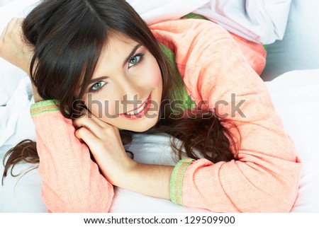 Woman bed portrait. Female model lying in bed. Close up smiling face .