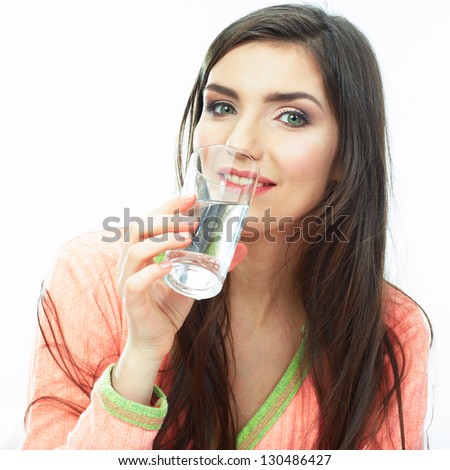 Woman drink water seating in bed. Female smiling model .