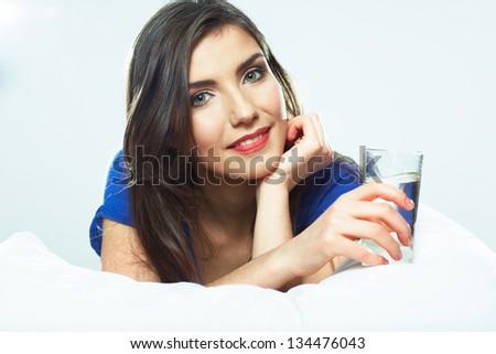 Woman hold water glass, seat in bed.