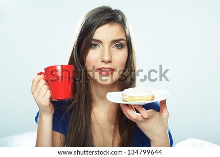 Woman hold coffee cup, seating in bed - white background isolated female model