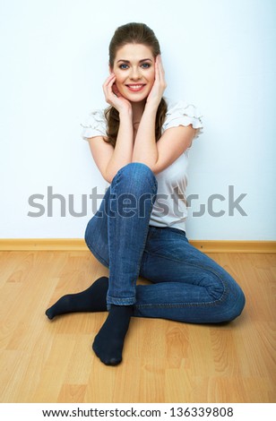 Young beauty seating woman casual style dressed. Female model against white background isolated portrait.