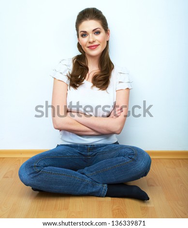 Portrait of beautiful young woman relaxing yoga pose on floor. Female model casual dressed.