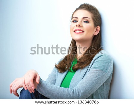 Young beauty seating woman casual style dressed. Female model against white background isolated portrait.