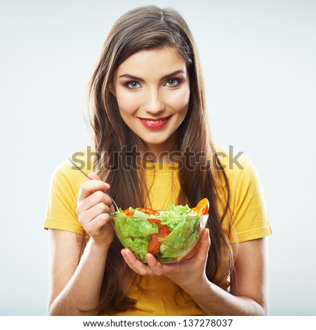Woman diet concept portrait. Female model hold green salad. Isolated portrait.