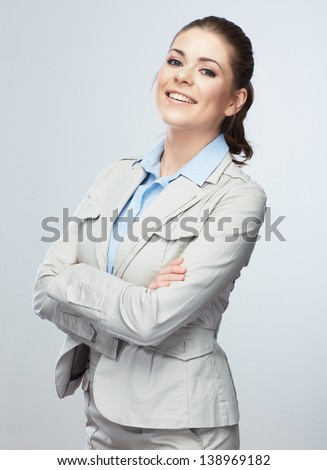 Business woman standing against isolated gray background. Female model.