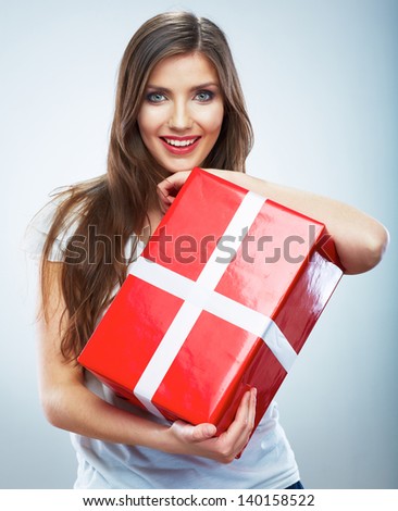 Portrait of young happy smiling woman red gift box hold. Isolated studio background female model.