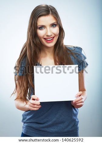 Teenager girl hold white blank paper. Young smiling woman show blank card. Girl portrait isolated on white background.