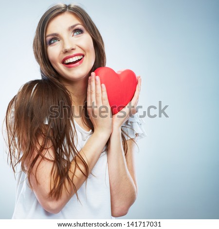Heart. Love symbol. Portrait of beautiful happy woman hold Valentine day symbol. Isolated studio background female model. Beautiful girl.