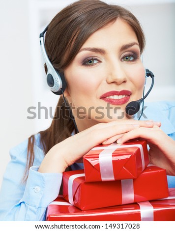 Close Up Smiling operator seat at table with red gift box. Happy business woman at office. Female business model posing.