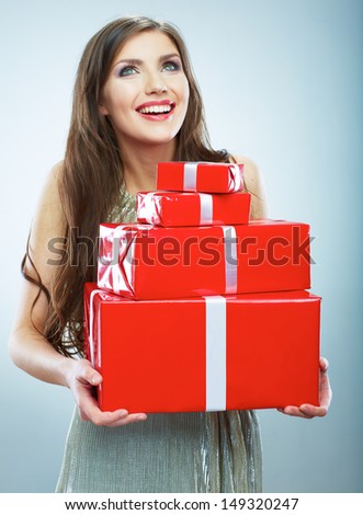 Young happy smiling woman hold red gift box. Isolated studio background female model.