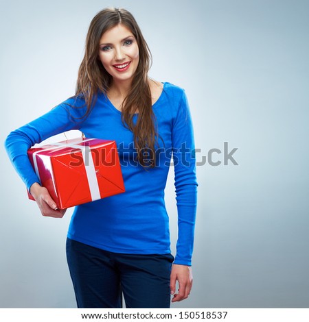 Portrait of young happy smiling woman hold red gift box. Isolated studio background female model.