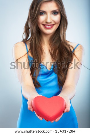 Heart, love symbol young happy woman hold. Isolated on studio background female model.