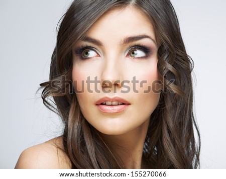 Beauty woman face close up portrait. Girl with long hair looking up side. Female model studio portrait.