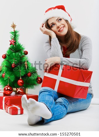 Santa girl isolated portrait with christmas gift, christmas tree.Young smiling woman.