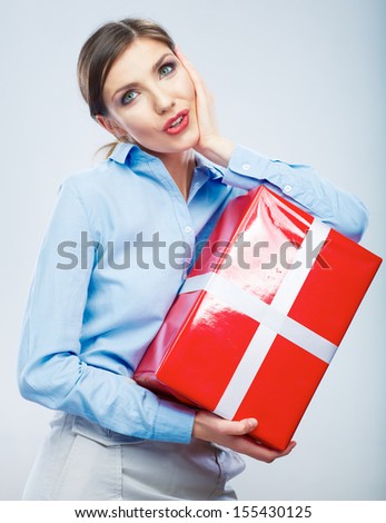 Business woman hold gift box in christmas color style, studio portrait. Young female model.
