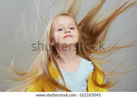 Portrait of fashion girl with long blond hair. Isolated portrait.