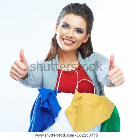 Portrait of happy smiling woman hold shopping bag with clothes. Thumb show. Female model isolated white  background.