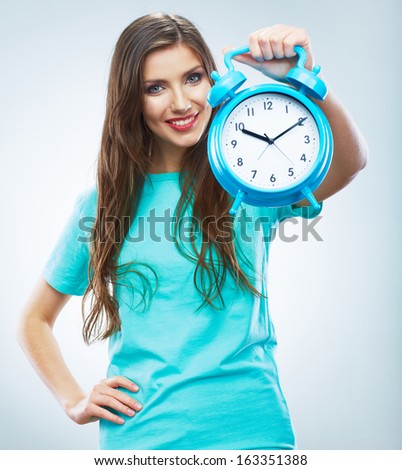 Young smiling woman hold watch. Beautiful smiling girl portrait. Isolated studio background female model.