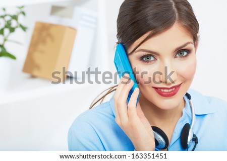 Smiling business woman on phone at office. Close up female portrait in white office. Posing young model.