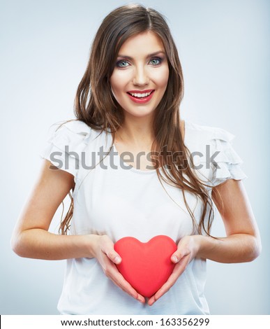 Heart. Love symbol. Portrait of beautiful happy woman hold Valentine day symbol. Isolated studio background female model. Beautiful girl.