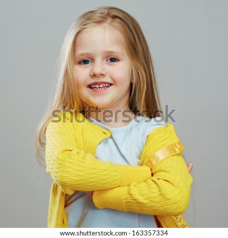 Happy girl child with long blond hair. Isolated portrait.