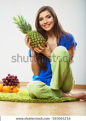 Woman diet food. Model seat on a floor. Fruit diet.