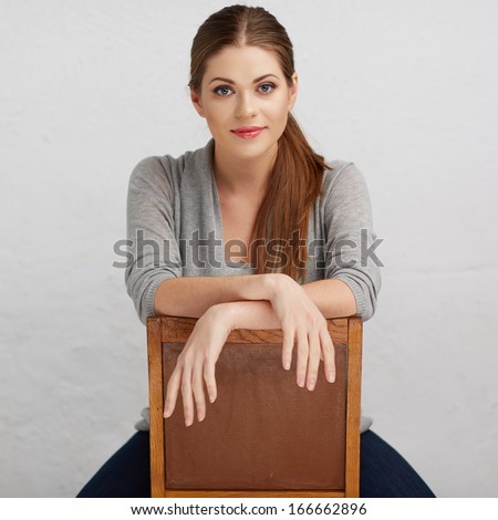 Woman sitting on chair , beautiful model . Chair back . Isolated .