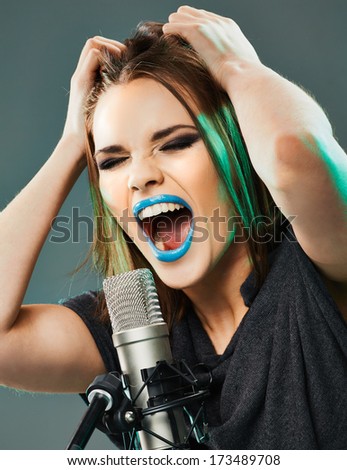 Beautiful young woman singer. Emotional teen girl music model.