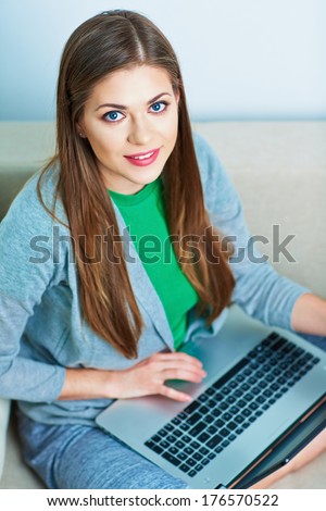 Woman working at home. Computer, laptop. Young female model.