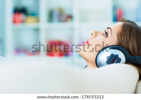 Young woman portrait with headphones music listening. Beautiful girl.