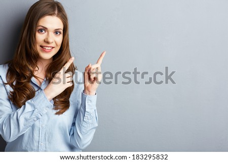 Smiling business woman finger pointing at the side. Isolated background.