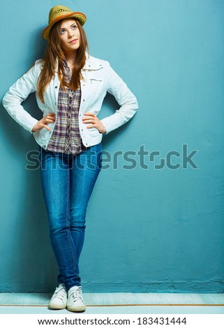 Woman full body portrait standing against blue. Fashion portrait.