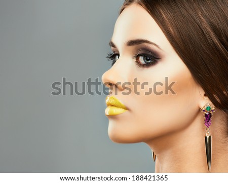 Beauty profile face woman close up portrait. Yellow lips. Yellow nails. Long hair.