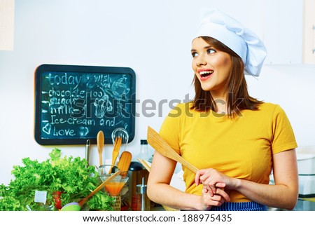 Young woman in kitchen. Girl cooking .
