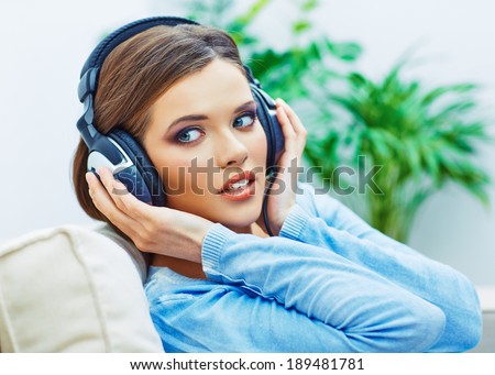 Beautiful teenager girl listening music. Face portrait.