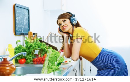 Beauty young woman prepare breakfast in kitchen. Music listening.