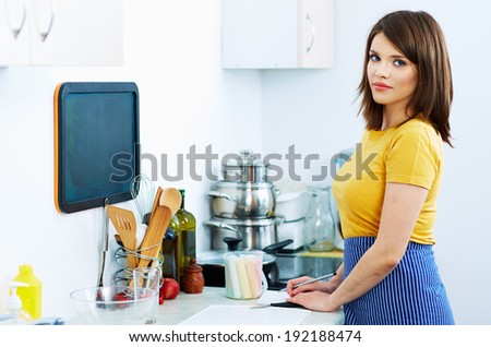 Beautiful woman in kitchen. Chef woman portrait.