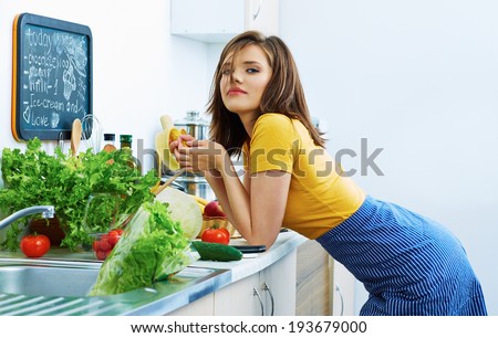 Woman eat in kitchen in cooking time. Bio fruit, vegetarian diet.