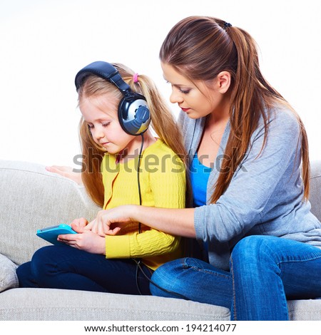 Mother with child learning home work with tab pc.