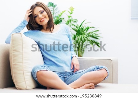 Beauty woman portrait. Home relax. Sofa sitting.