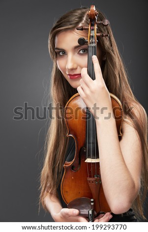 Music portrait of young woman.  Violin play.Female beautiful model.