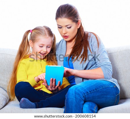 Mother with daughter sitting on sofa home work learning. Family portrait.