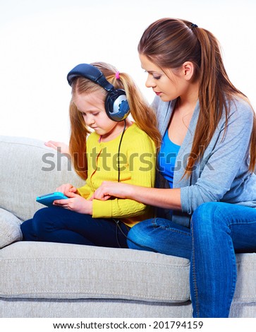Mother with child learning home work with tab pc.