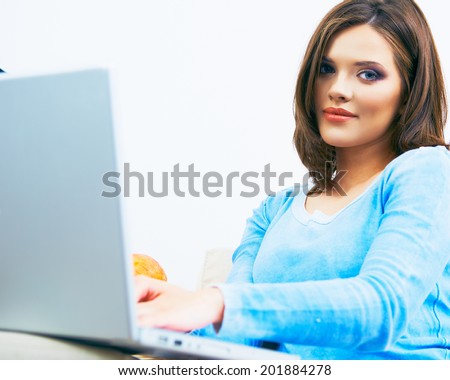 Woman using laptop, sitting on sofa. Beautiful girl life style portrait.